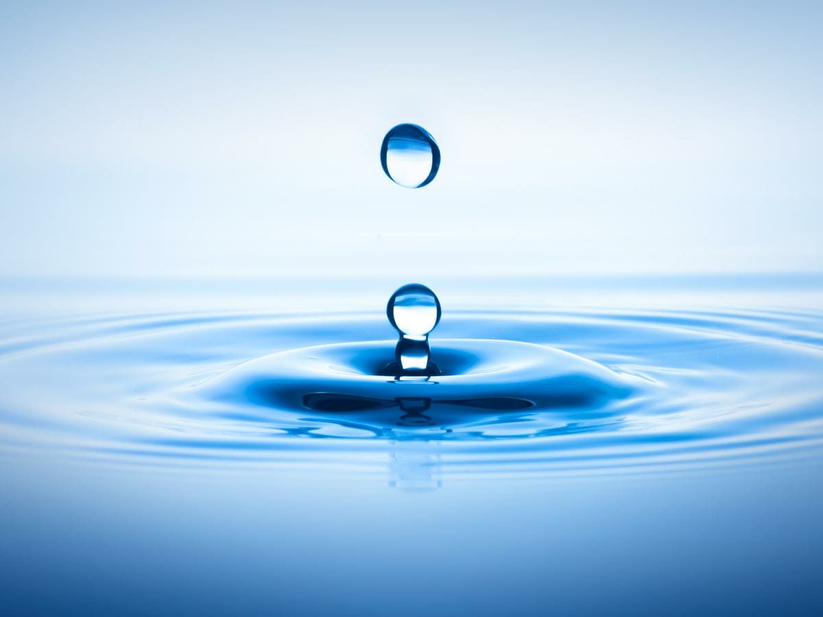 Drops falling into water and creating ripples: symbolic image of impactful copy